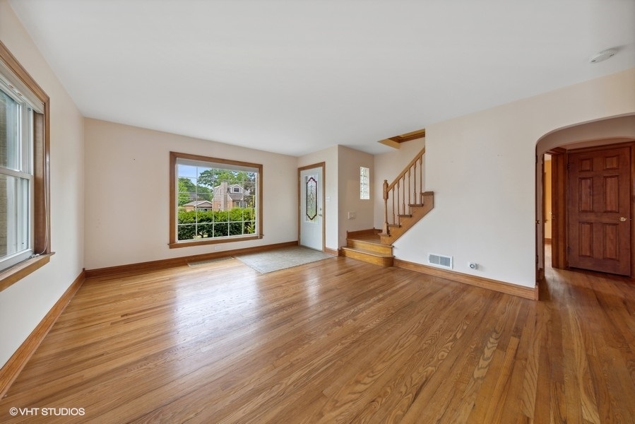 238 West Hickory Road Lombard, IL 60148 - Photo 4 of 17 an empty room with wooden floor and windows