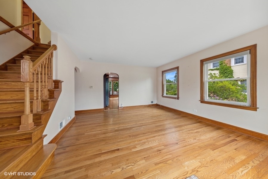 238 West Hickory Road Lombard, IL 60148 - Photo 5 of 17 a view of an empty room with wooden floor and a window