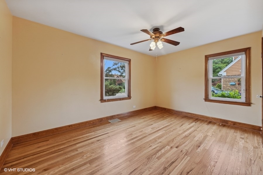238 West Hickory Road Lombard, IL 60148 - Photo 6 of 17 a view of an empty room with window and wooden floor