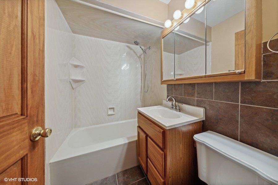 238 West Hickory Road Lombard, IL 60148 - Photo 7 of 17 a bathroom with a sink toilet vanity and shower