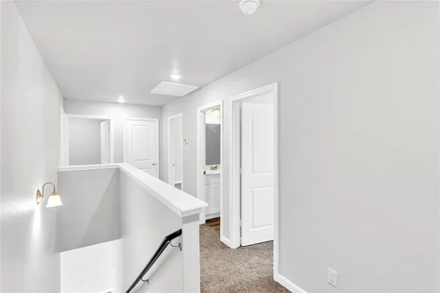 a view of a hallway with white walls