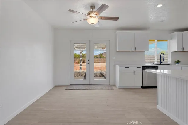 a view of a kitchen with a sink and a window
