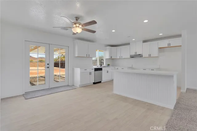 a view of kitchen with windows and ceiling fan