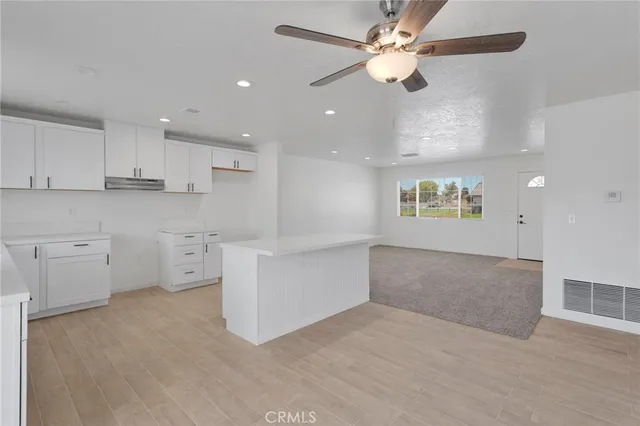 a view of kitchen with center island and stainless steel appliances