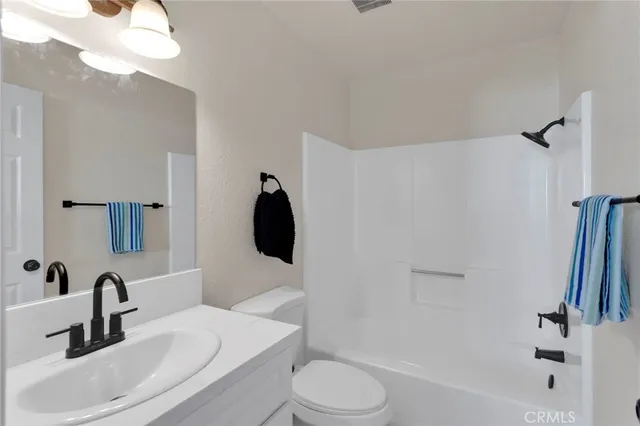 a bathroom with a sink a toilet and a bathtub