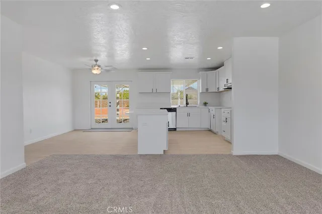 a view of a kitchen with white cabinets
