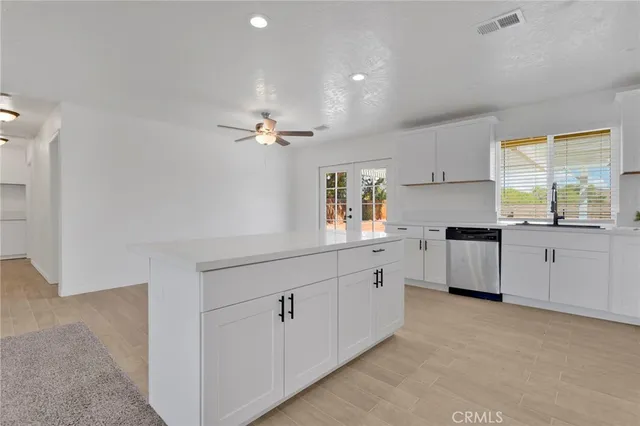 a kitchen with white cabinets and white appliances