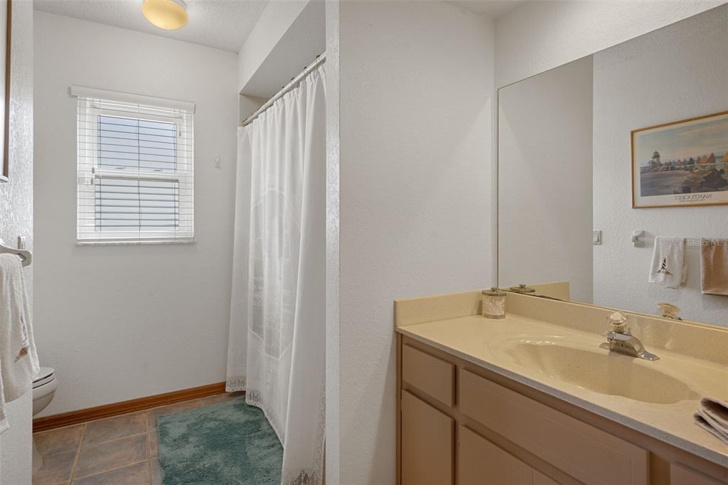 5035 Harbinger Road Spring Hill, FL 34608 - Photo 41 of 47 a bathroom with a sink and a mirror