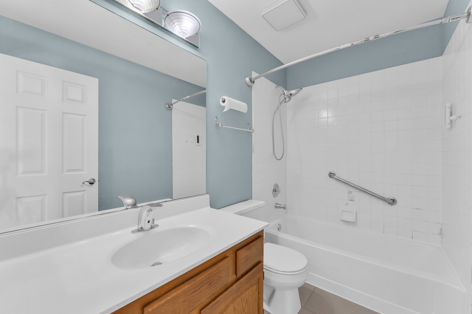 6063 Morningside Court Gurnee, IL 60031 - Photo 34 of 58 a bathroom with a sink a toilet and a large mirror