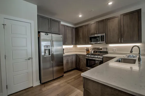 a kitchen with a refrigerator stove and sink