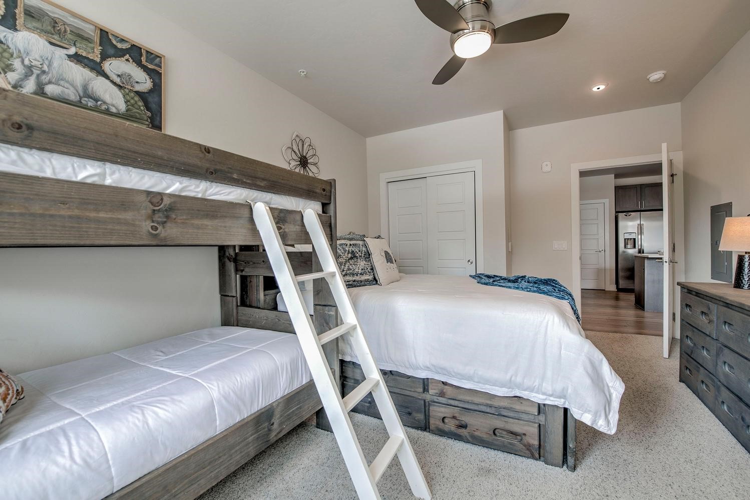 235 La Bonte Street, Unit 108 Dillon, CO 80435 - Photo 28 of 38 a bedroom with a bed and a chandelier