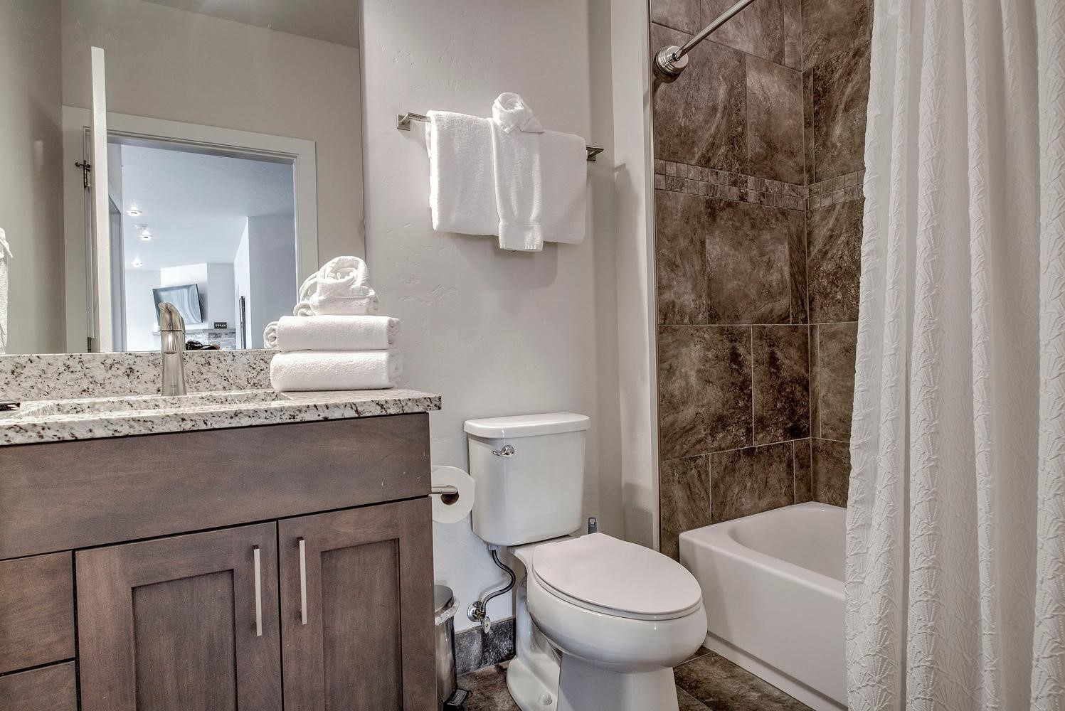 235 La Bonte Street, Unit 108 Dillon, CO 80435 - Photo 29 of 38 a bathroom with a granite countertop sink toilet and shower
