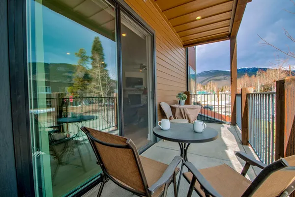 a view of a porch with furniture and a yard