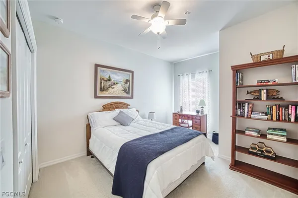 a spacious bedroom with a bed and a book shelf