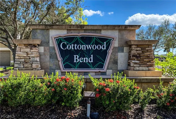 a sign that is sitting in front of flowers