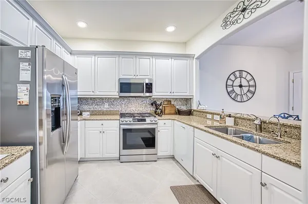 a kitchen with a sink cabinets and stainless steel appliances