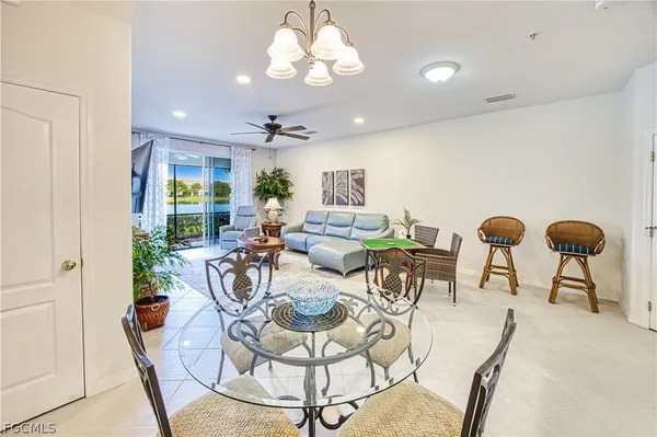 a view of a dining room with furniture and chandelier