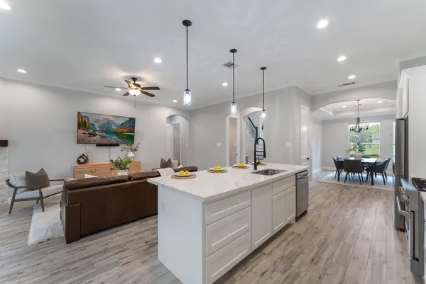 a view of a kitchen counter top space a sink appliances and wooden floor