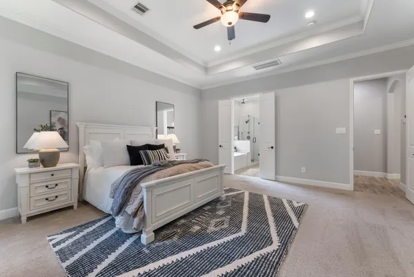 a bedroom with a bed and a chandelier