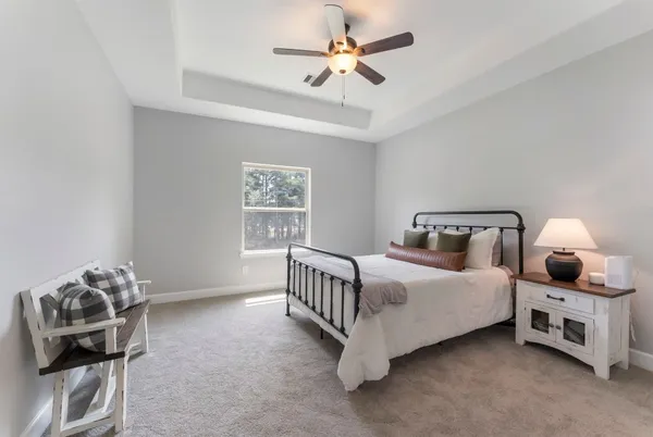a bedroom with a bed and a chandelier