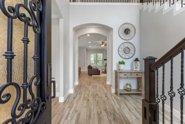 a view of a hallway with wooden floor