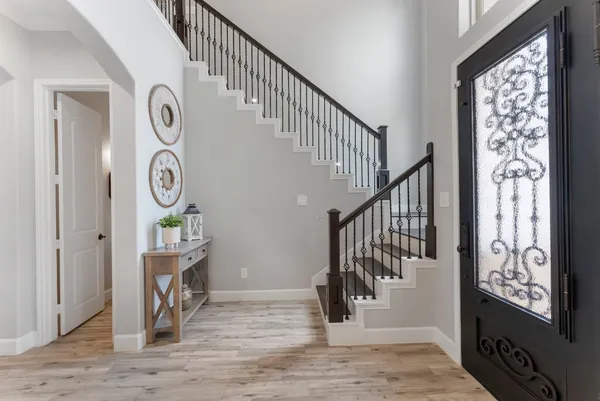 a view of entryway and hall with wooden floor