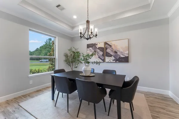 a dining room with furniture a window and a chandelier