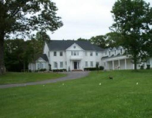 4 Storm Ridge Road Newtown, CT 06470 - Photo 1 of 1 a front view of a house with a garden