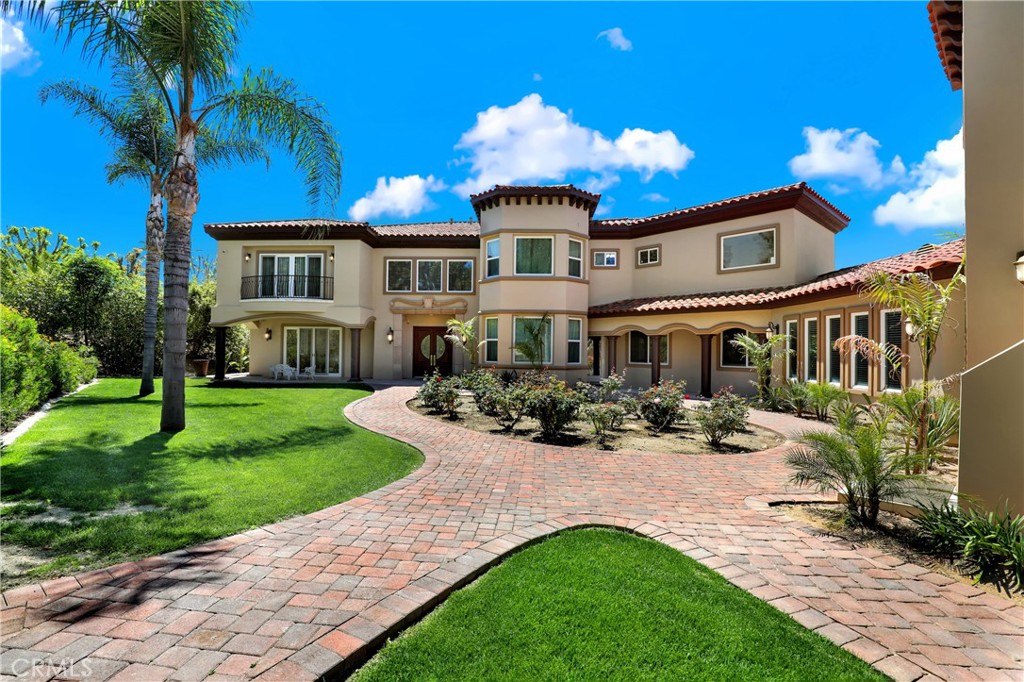 a front view of a house with garden and porch