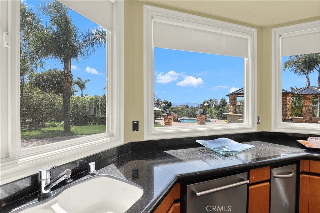 7231 Brandon Court Riverside, CA 92506 - Photo 17 of 69 a bathroom with a granite countertop sink mirror and window