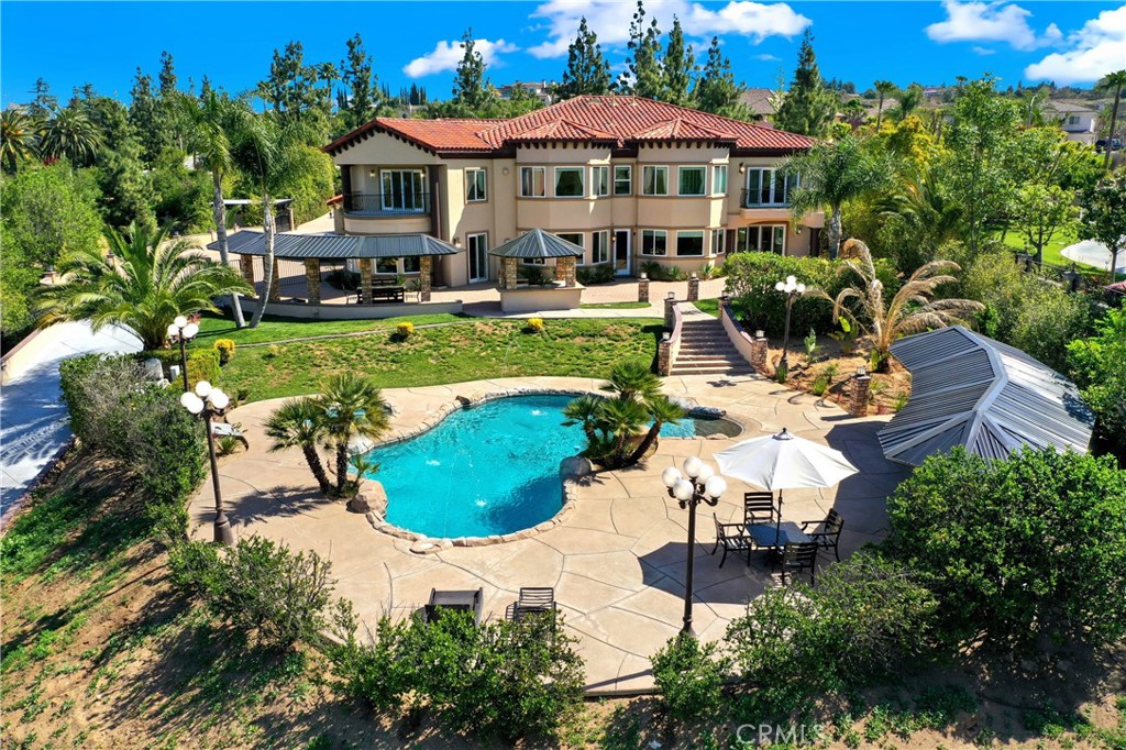 7231 Brandon Court Riverside, CA 92506 - Photo 2 of 69 a swimming pool with outdoor seating water slide and yard