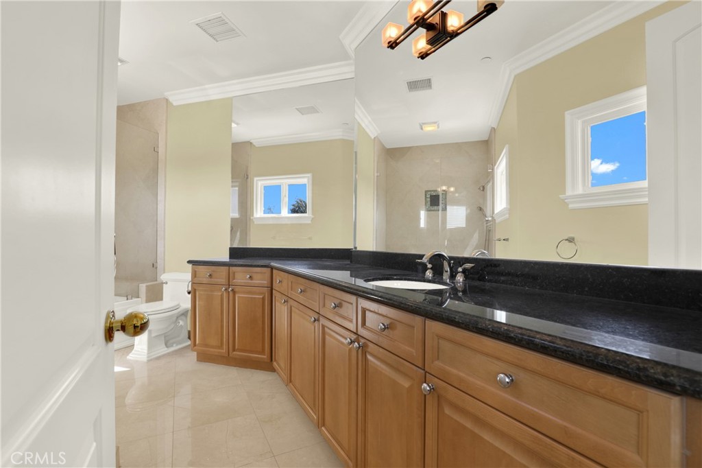 7231 Brandon Court Riverside, CA 92506 - Photo 44 of 69 a spacious bathroom with a granite countertop tub sink and mirror