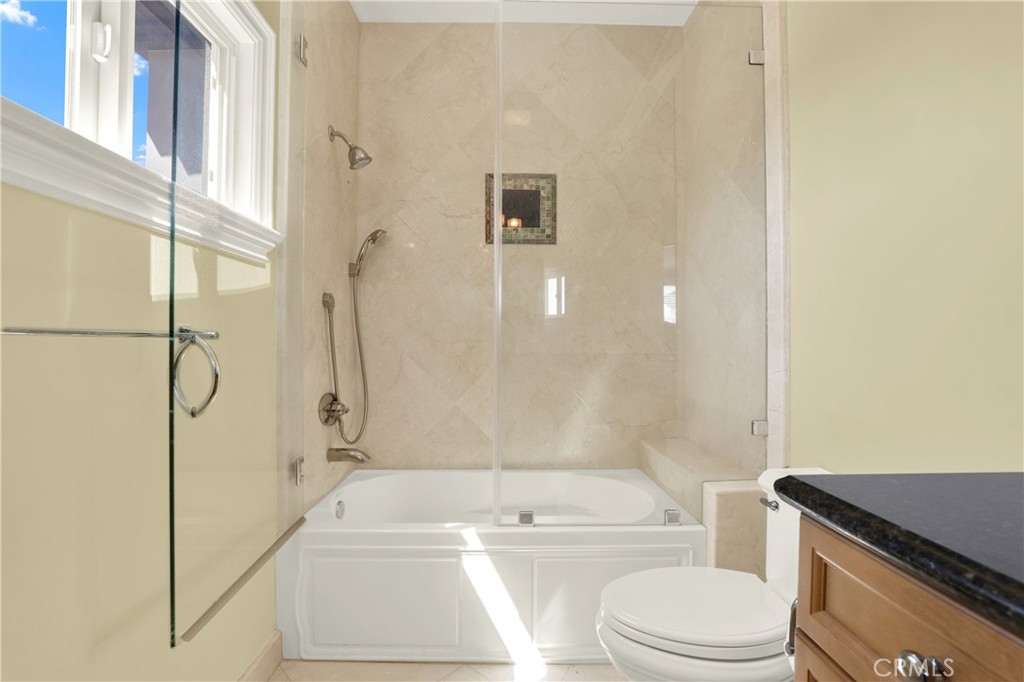 7231 Brandon Court Riverside, CA 92506 - Photo 45 of 69 a bathroom with a granite countertop bathtub shower sink vanity and toilet