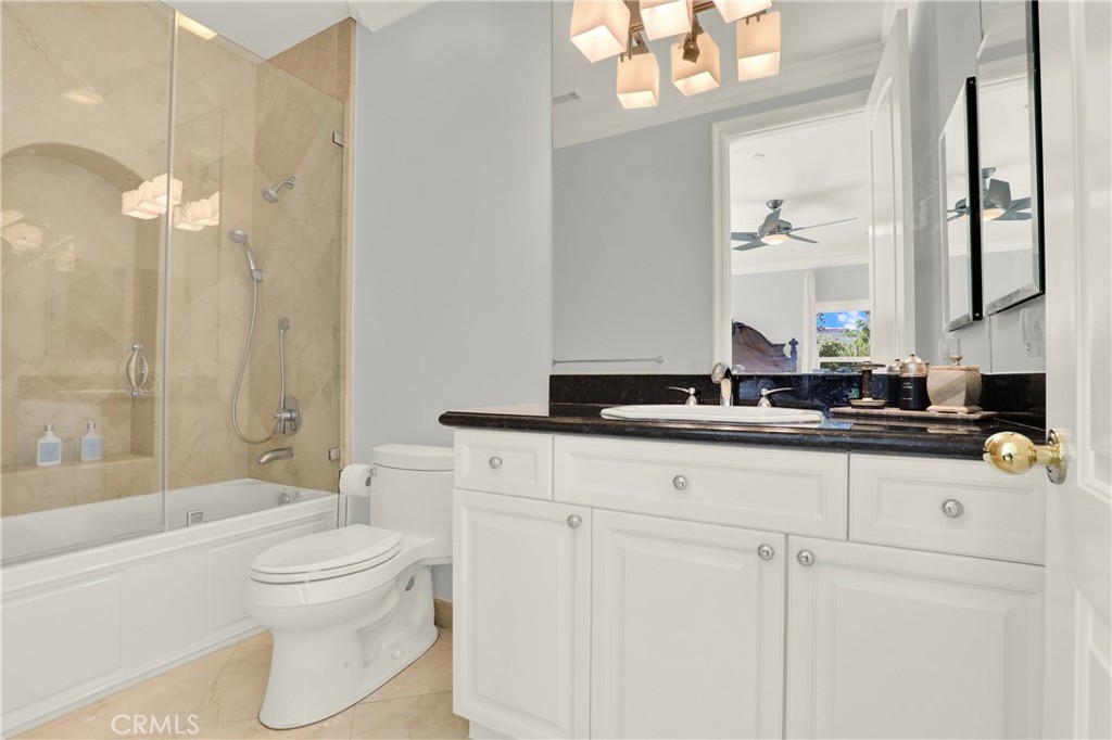 7231 Brandon Court Riverside, CA 92506 - Photo 52 of 69 a bathroom with a toilet a sink a mirror a bathtub and vanity