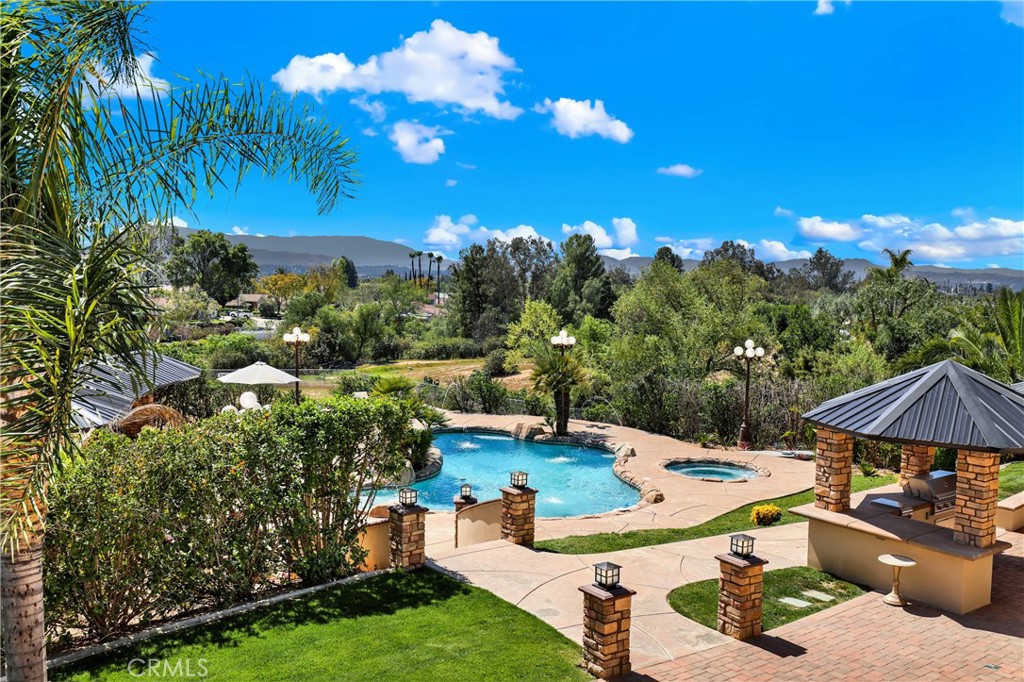 7231 Brandon Court Riverside, CA 92506 - Photo 54 of 69 a view of a patio with table and chairs under an umbrella