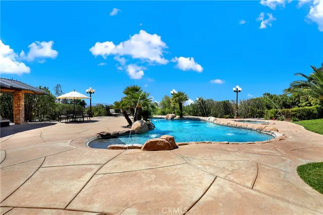 a dining hall with stainless steel appliances lots of furniture and view of living room