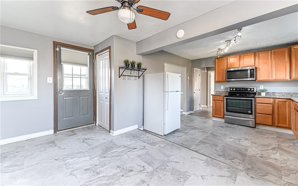 1711 Mercer Street Aliquippa, PA 15001 - Photo 5 of 23 a view of kitchen with sink microwave and refrigerator