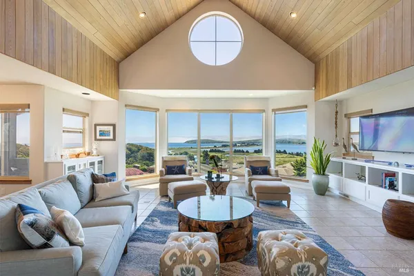 a living room with furniture a rug and a large window