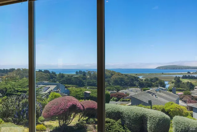 a bedroom with a bed and glass window