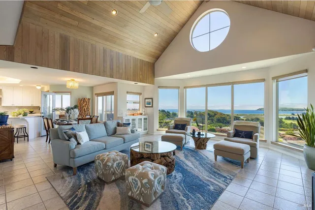a living room with furniture large window and a fireplace