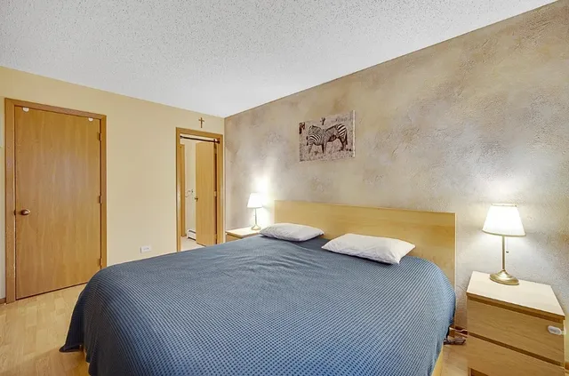 a bedroom with a bed and a night stand