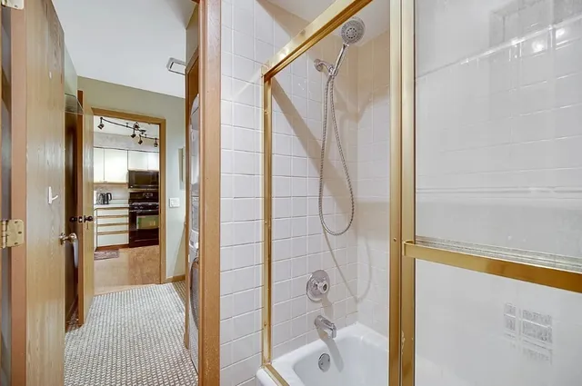 a bathroom with a glass shower door and a sink