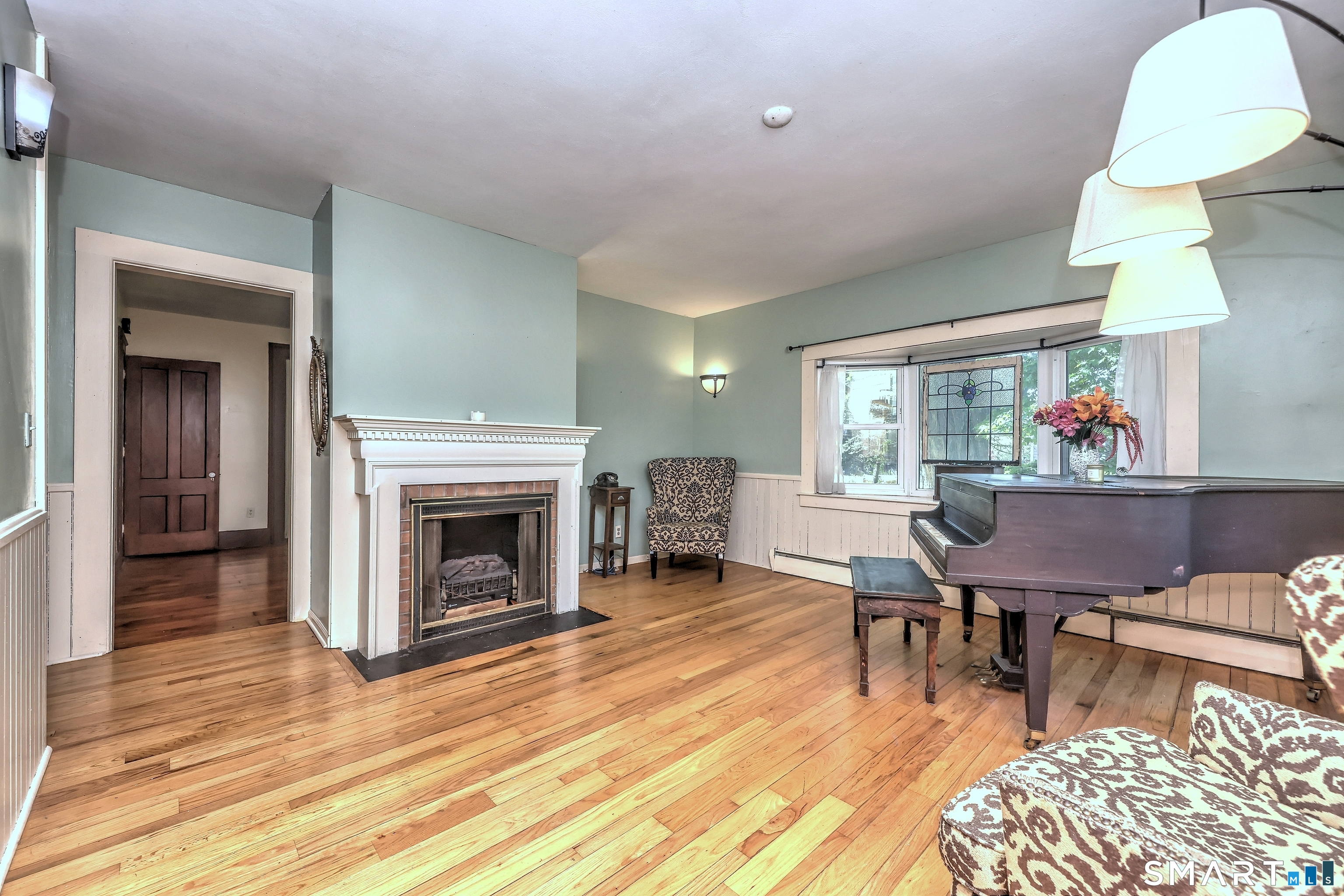 186 Jones Hill Road West Haven, CT 06516 - Photo 17 of 33 a living room with furniture a fireplace and a table
