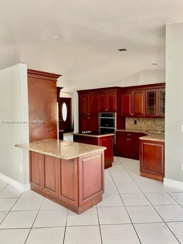 a kitchen with stainless steel appliances a sink and cabinets