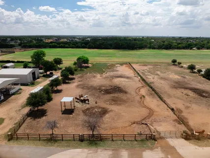 an aerial view of a house with outdoor space