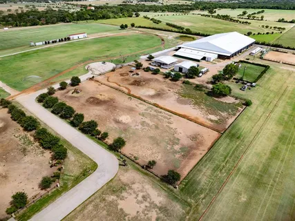 an aerial view of a house with a yard basket ball court and outdoor seating