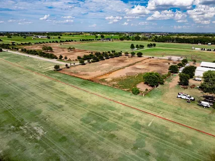 an aerial view of a house with a yard basket ball court and outdoor seating