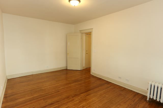 4716 North Racine Avenue, Unit 2E Chicago, IL 60640 - Photo 13 of 19 a view of an empty room with wooden floor