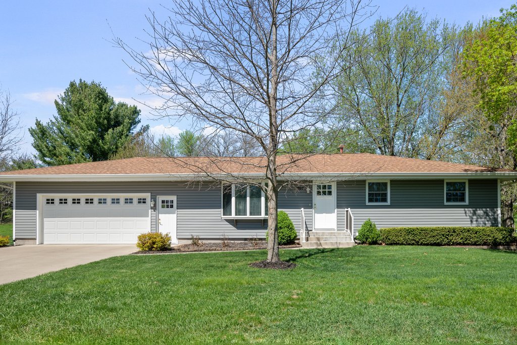 207 Amber Lane Geneseo, IL 61254 - Photo 1 of 57 a front view of a house with a garden