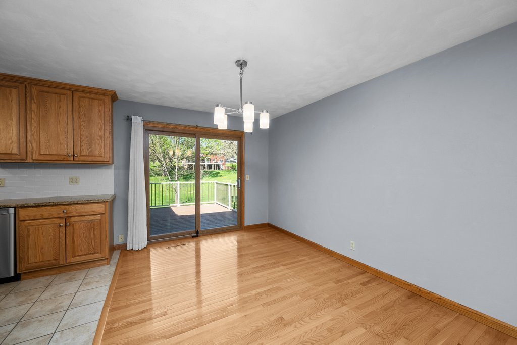 207 Amber Lane Geneseo, IL 61254 - Photo 11 of 57 a view of empty room with wooden floor and fireplace